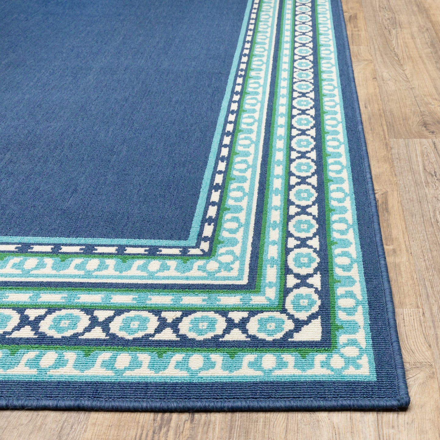 Tapis d'intérieur/extérieur Style Haven Martinque Green à bordure marine~
